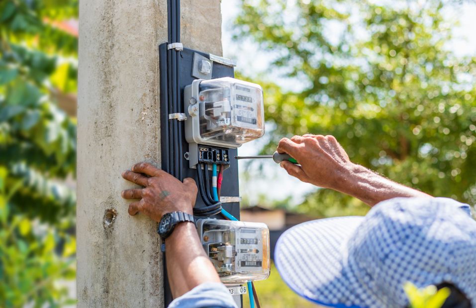 Worker using a screwdriver on electrical box