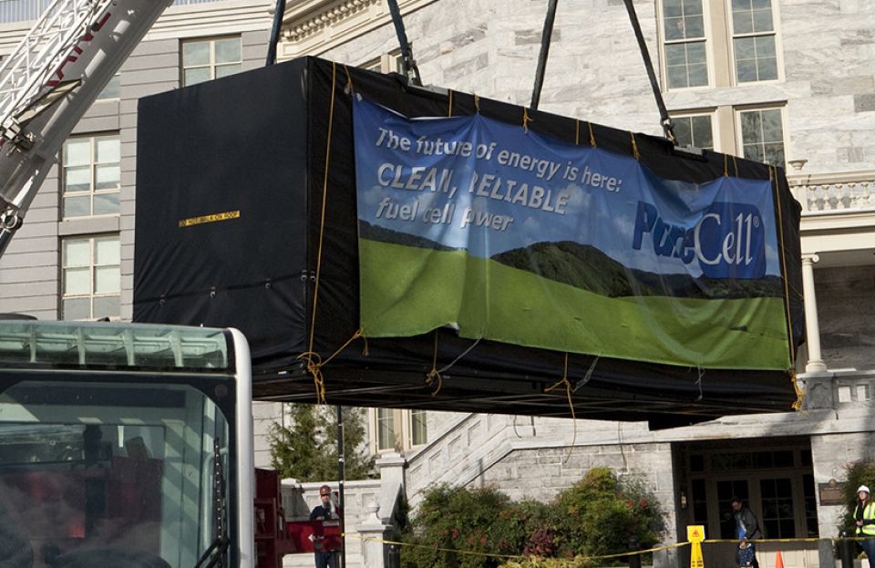 Fuel cell being delivered via crane to a building